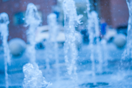 The gush of water of a fountain. Splash of water in the fountain, abstract image. bokeh of blue waterの写真素材