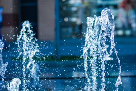 The gush of water of a fountain. Splash of water in the fountain, abstract image. bokeh of blue waterの写真素材