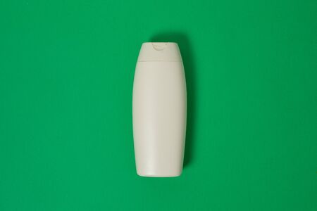 Cosmetics, Moisturizer, Bottle. Blank plastic cosmetics bottle isolated on green background with copy spaceの写真素材