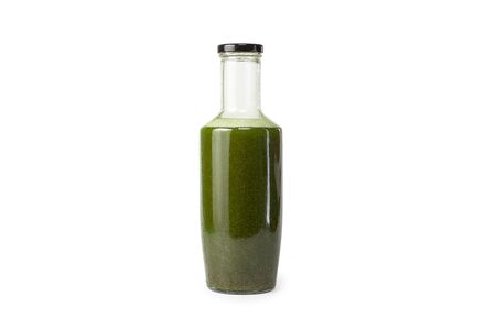 Fresh celery spinach juice in a glass bottle isolated on white background. Healthy eating Detox juice dietの写真素材