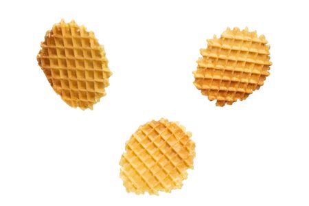 Set Round yellow waffles in different positions of flight on a white background. Round Belgian waffles isolated on white background.の写真素材