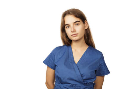 Young beautiful woman doctor in blue surgical gown isolated on white backgroundの写真素材