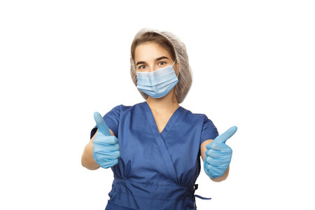 Female hand of a surgeon in a blue medical glove shows a thumbs up sign isolated on a white backgroundの写真素材