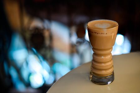 A glass of invigorating coffee. Latte in a glass cup with a delicious foam.の写真素材