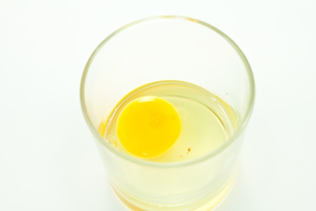Raw eggs in a glass cupの写真素材