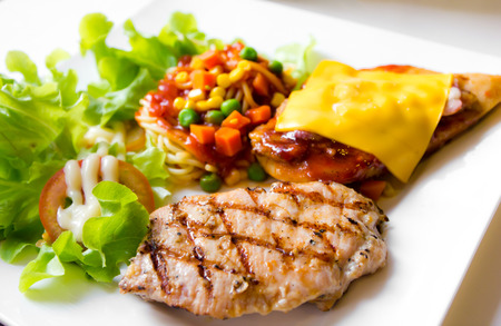 Mixed grill meat with spaghetti on plateの写真素材