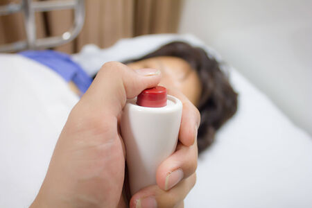 The hand holding a help or assist call button of emergencyの写真素材