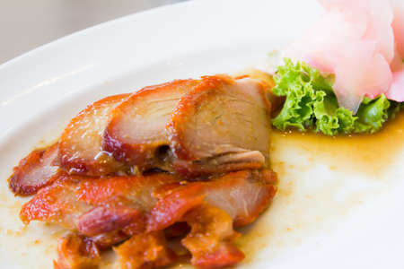 roast pork on white plateの写真素材