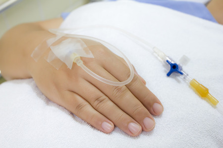 IV solution in a patients handの写真素材