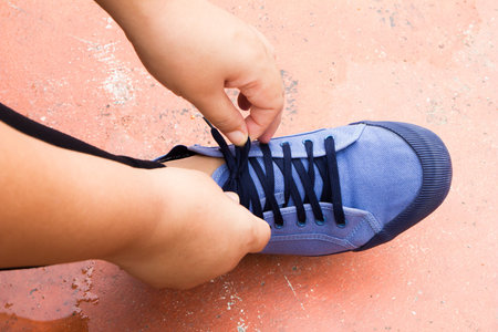 woman tying laces of running shoesの写真素材