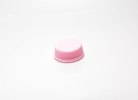 pink plastic cosmetics jar on white background