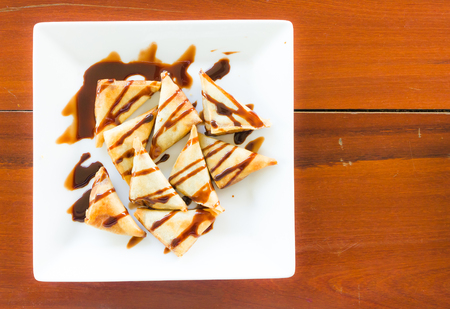 Spring Rolls bananas and chocolate on a plateの写真素材