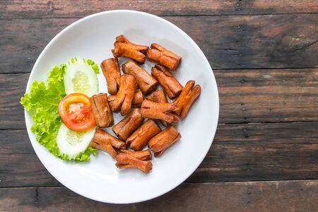 pork sausage fried on white plateの写真素材