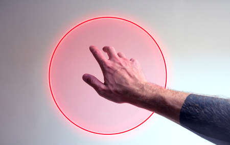 Hand entering in a neon light as a gate for metaverseの写真素材