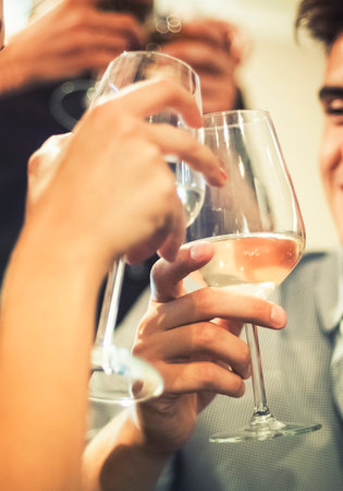 Group of friends toasting together with white wineの写真素材