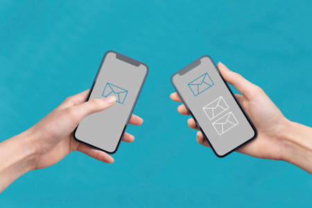 Hands holding mobile phones and transfer messagesの写真素材