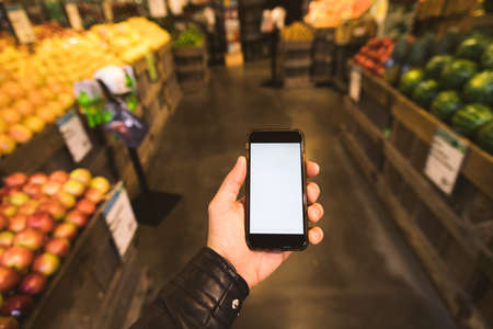 shopping list on the phone at the groceryの写真素材