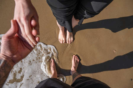 Couple together at beach hand in handの写真素材