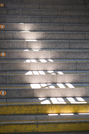 Subway staircase with directional arrows and dramatic light