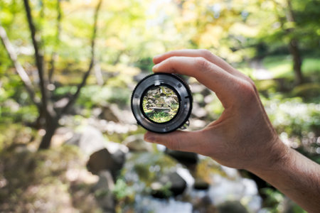 Lens focus on forest stream through camera lensの写真素材