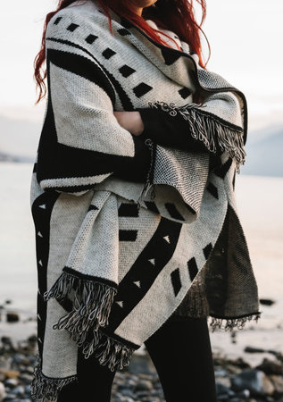 Woman wearing patterned wool blanket outdoors