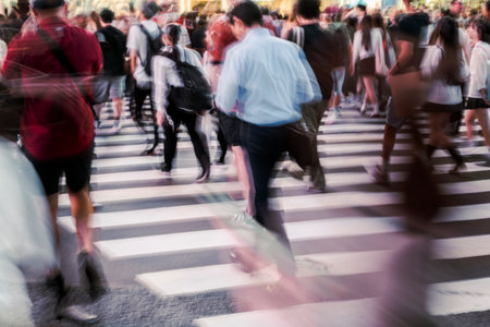 Evening Rush of People Crossing Busy Streetの写真素材
