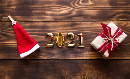 Christmas flat lay with new year 2021 symbol of gold numbers in the center. Holiday atmosphere,...