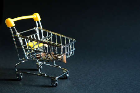 Empty grocery cart from a supermarket on a black background. Black Friday, shopping cart, shopping, online store, sale, discounts. Space for textの写真素材