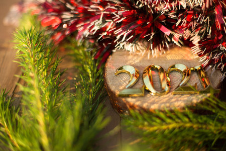The symbol of the new year 2021 is a golden number on a wooden background with Christmas...