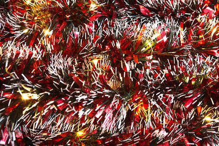 Christmas background with blur Golden lights of garlands in the bokeh. Red tinsel, Christmas tree. New Year. Copy space.の写真素材