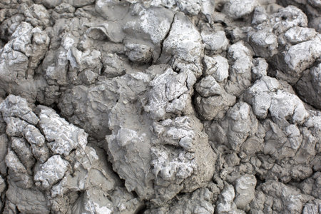 The texture of gray cracked earth, dried volcanic clay with cracks. Ultimate Gray. Natural background, copyspaceの写真素材