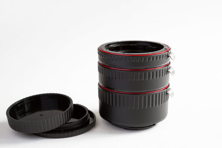Macro rings for camera lens close-up on a gray background. Professional macro photography, additional features, plastic rings with a chip. Three rings of different sizes with different focal lengths.の写真素材