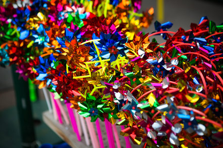 A collection of colorful toy windmills on the shop window. Entertainment for childrenの写真素材