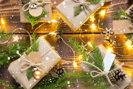 Pack a gift for Christmas and new year in eco-friendly materials: kraft paper, live fir branches,...