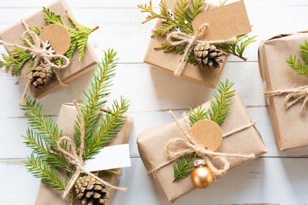 Gift box for Christmas and new year in eco-friendly materials: kraft paper, live fir branches,...