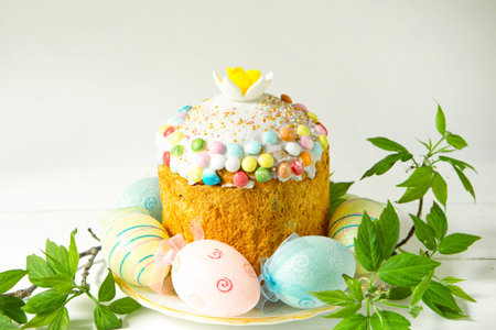 Easter cake with painted eggs on a platter in a gray interior. traditional festive food