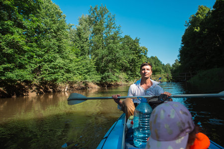 Family kayak trip. Father and daughter rowing boat on the river, a water hike, a summer adventure....