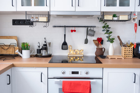The interior of the kitchen in the house is decorated with red hearts for Valentine's Day. Decor on...