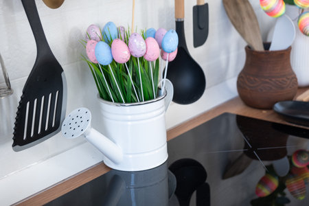 Interior of kitchen and details of decor of utensils with Easter decoration of colorful eggs in a loft style. Festive interior of a country houseの写真素材