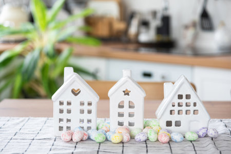 Key to house of cozy home with Easter decor with rabbit and eggs on table of kitchen. Building, design, project, moving to new house, mortgage, insurance, rent and purchase real estateの写真素材