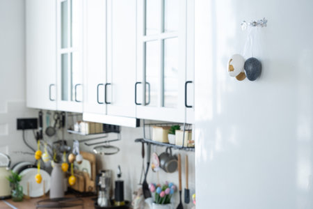 Interior of kitchen and details of decor of utensils with Easter decoration of colorful eggs in a loft style. Festive interior of a country houseの写真素材