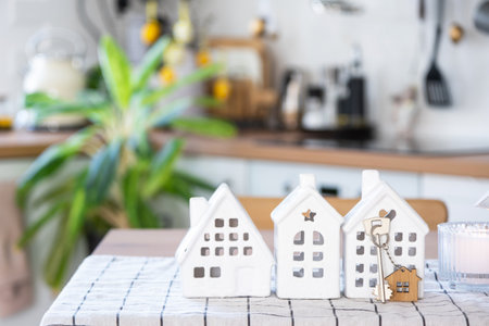 Key to house of cozy home on table of kitchen. Building, design, project, moving to new house, mortgage, insurance, rent and purchase real estateの写真素材