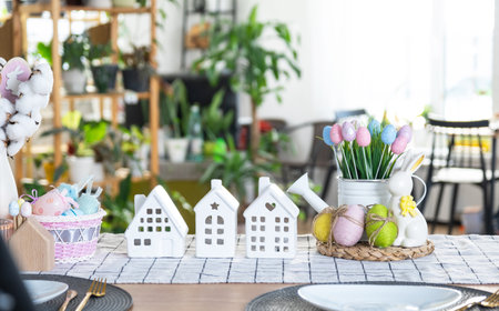 Key to house of cozy home with Easter decor with rabbit and eggs on table of kitchen. Building, design, project, moving to new house, mortgage, insurance, rent and purchase real estateの写真素材