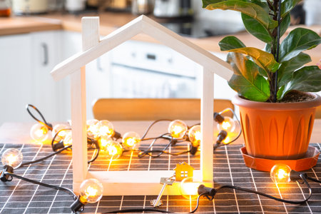 Key to house of cozy home on table of kitchen. Building, design, project, moving to new house, mortgage, insurance, rent and purchase real estateの写真素材