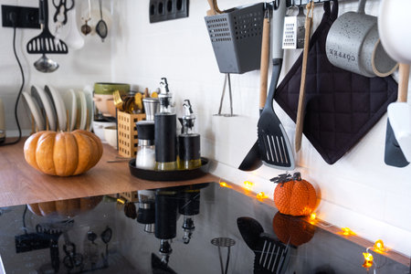 Decor of the white classic kitchen with pumpkins for Halloween and harvest. Autumn mood in the home interior, modern loft style.の写真素材
