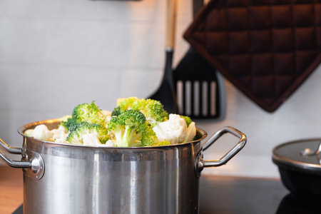 Broccoli and cauliflower are steamed in a saucepan - healthy diet, baby food, cooking in a steamerの写真素材