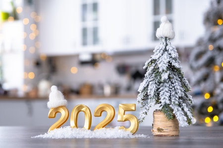 Golden number 2025 on table in background of cozy white kitchen with Christmas tree and Christmas...