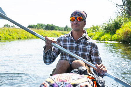 Family kayak trip. Father and daughter rowing boat on the river, a water hike, a summer adventure. Eco-friendly tourism, active and healthy lifestyleの写真素材