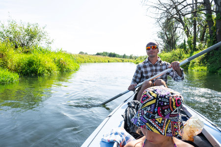 Family kayak trip. Father and daughter rowing boat on the river, a water hike, a summer adventure. Eco-friendly tourism, active and healthy lifestyleの写真素材