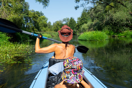 Family kayak trip. Mom and daughter rowing a boat on the river, a water hike, a summer adventure....